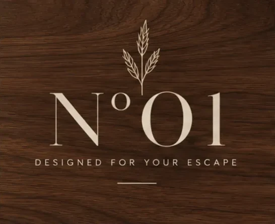 The Nº01 wordmark and wheat sprig with the words Designed for your escape, in cream on dark walnut
